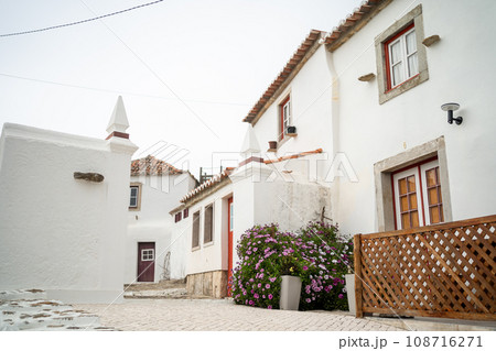 Small streets in Portugal surrounded by white two-storey houses 108716271