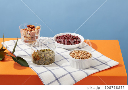 Some types of nuts and beans such as almond, cashew nuts, soybeans, green beans and red beans contained inside few bowls. For healthy concept advertisement Some types of nuts and beans such as almond, cashew nuts, soybeans, green beans and red beans contained inside few bowls. For healthy concept advertisement 108718853