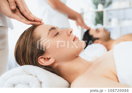 Caucasian couple enjoying relaxing anti-stress head massage. Quiescent 108720088