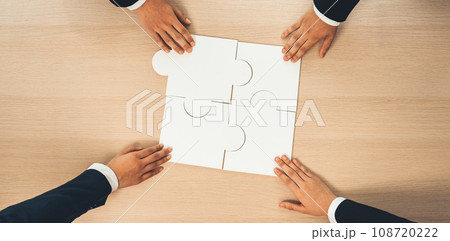 Top view panorama banner of business team assembling jigsaw puzzle. Shrewd 108720222