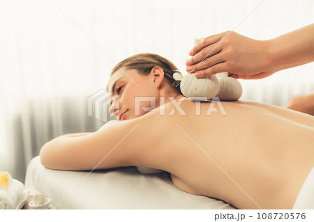 Hot herbal ball spa massage body treatment at day spa . Quiescent Hot herbal ball spa massage body treatment at day spa . Quiescent 108720576