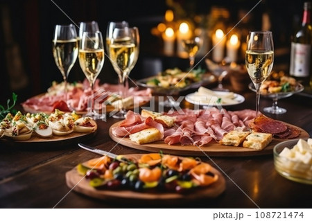Light snacks in a plate on a buffet table. Assorted mini canapes, delicacies and snacks, restaurant food at event. A gala reception. Decorated delicious table for a party goodies. 108721474