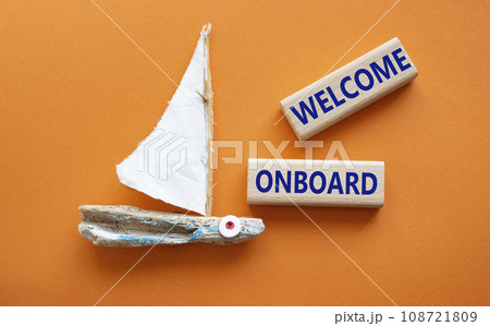 Welcome onboard symbol. Concept words Welcome onboard on wooden blocks. Beautiful orange background with boat. Business and Welcome onboard concept. Copy space. Welcome onboard symbol. Concept words Welcome onboard on wooden blocks. Beautiful orange background with boat. Business and Welcome onboard concept. Copy space. 108721809