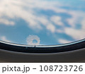 Tiny window hole with ice crystal, A close up of small bleed hole on airplane window when flying in the sky. 108723726
