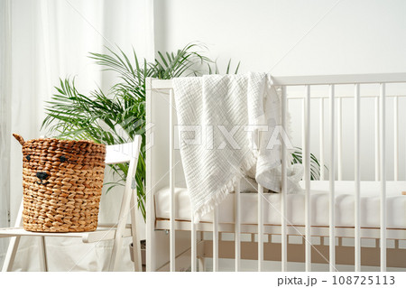 Baby bed and basket in nursery room interior 108725113