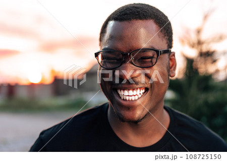 Young african man portrait standing in the street 108725150