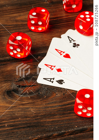 Playing cards and dice cubes on wooden background 108725266