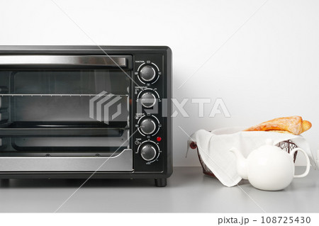 Electric mini oven on gray background studio shot 108725430