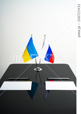 Russia and Ukraine flags on negotiation table Russia and Ukraine flags on negotiation table 108725432