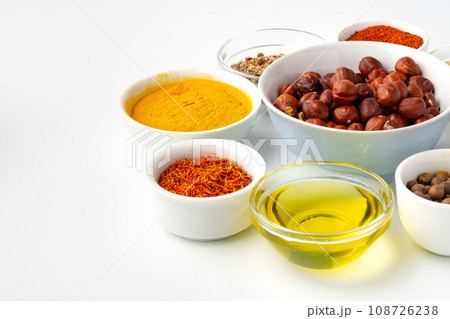 Bowls with spices and cooking ingredients on white background 108726238