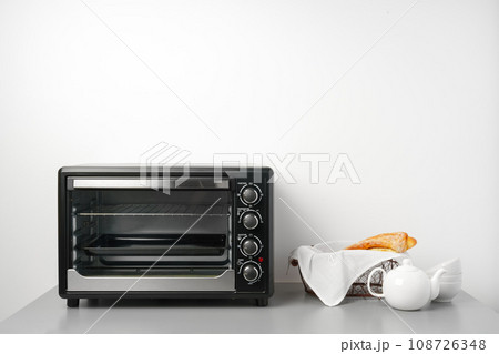 Electric mini oven on gray background studio shot Electric mini oven on gray background studio shot 108726348