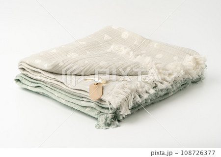 Warm cotton gray blanket with paper tag on white background Warm cotton gray blanket with paper tag on white background 108726377