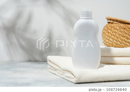 White cosmetics container mockup with towels on gray background 108726640