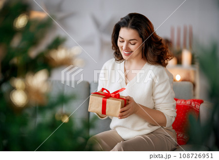 woman with Christmas present woman with Christmas present 108726951