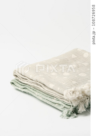 Gray and green muslin blankets on white background 108726958