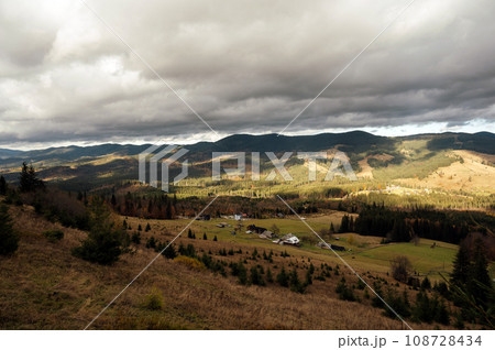 Golden autumn in the Carpathians. Mining arrays combined with trees with yellow leaves. Beautiful clouds and sun Golden autumn in the Carpathians. Mining arrays combined with trees with yellow leaves. Beautiful clouds and sun 108728434
