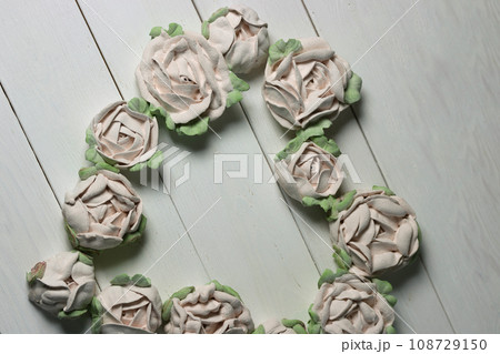 Flowers from marshmallows. Homemade marshmallows. Laid out in the shape of a heart. On white boards. Photographed from above. Flowers from marshmallows. Homemade marshmallows. Laid out in the shape of a heart. On white boards. Photographed from above. 108729150