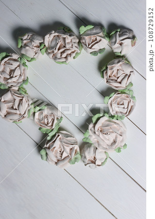 Flowers from marshmallows. Homemade marshmallows. Laid out in the shape of a heart. On white boards. Photographed from above. Flowers from marshmallows. Homemade marshmallows. Laid out in the shape of a heart. On white boards. Photographed from above. 108729152