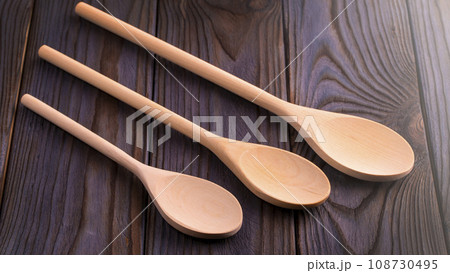Wood spoons on wooden table. Kitchen utensils on soft sunlight 108730495