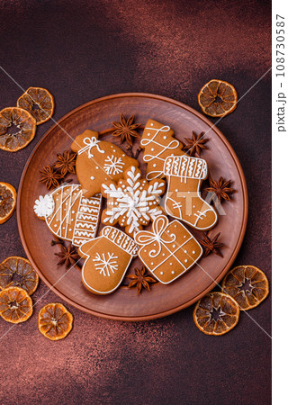 Beautiful Christmas gingerbread cookies of different colors on a ceramic plate 108730587