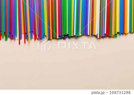 Heap of colorful plastic drinking straws on Colored background, flat lay. Copy Space for text Heap of colorful plastic drinking straws on Colored background, flat lay. Copy Space for text 108731298