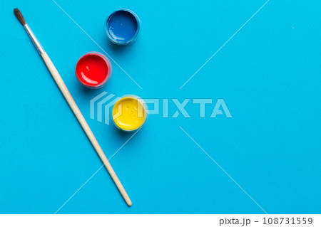 art palette with paint and brushes, close up. Top view with empty space. workplace for creativity. home teaching concept drawing 108731559