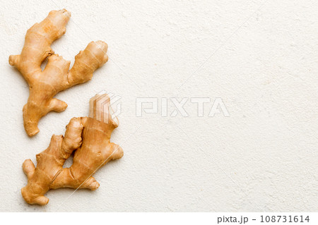 Finely dry Ginger powder in bowl with green leaves isolated on colored background. top view flat lay 108731614