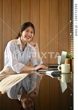 Portrait of confident young businesswoman using laptop computer at workplace 108731899