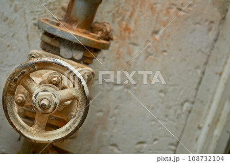 Plumbing. Sewage. Water valve, old rusty faucet in the basement Plumbing. Sewage. Water valve, old rusty faucet in the basement 108732104