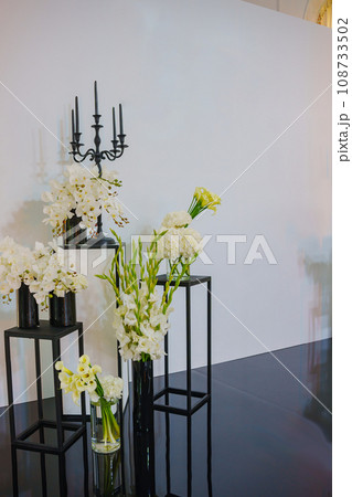 Photo zone with bouquets of flowers in the wedding banquet hall.  108733502