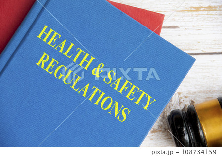 Top view of Health and Safety Regulations on blue book with gavel background. Law concept Top view of Health and Safety Regulations on blue book with gavel background. Law concept 108734159