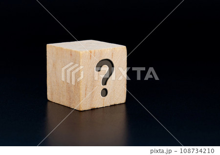 Question mark engraved on wooden cube with dark background. Question and Answer session. 108734210