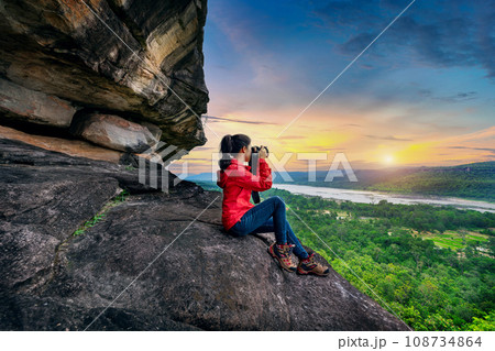 Tourist taking a photo at Pha taem national park in Ubon ratchathani, Thailand. Tourist taking a photo at Pha taem national park in Ubon ratchathani, Thailand. 108734864
