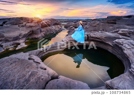 Tourist sitting at Sam Phan Bok in Ubon ratchathani, Thailand. Grand canyon of Thailand. Tourist sitting at Sam Phan Bok in Ubon ratchathani, Thailand. Grand canyon of Thailand. 108734865