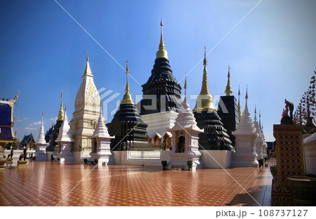 The panoramic scene of Wat Den Sali Si Mueang Kaen that is the most unique Lana temple. There are many blue elegant Pagoda displays among the fresh sunshine, Chiang Mai, Thailand.  108737127