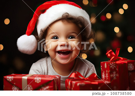 Festive Toddler Delight A Joyful Portrait of a Smiling Toddler in a Santa Hat on Christmas Eve, Against a Bokeh Background. created with Generative AI 108738580