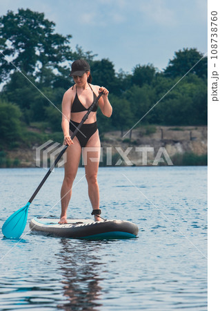 standing woman on supboard 108738760