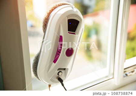 Modern device for cleaning glass from dirt and streaks. Robot washer vacuum cleaner with microfiber. Safety for window cleaning and fall protection. Modern device for cleaning glass from dirt and streaks. Robot washer vacuum cleaner with microfiber. Safety for window cleaning and fall protection. 108738874