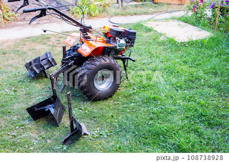 Plow and hiller complete with a walk-behind tractor for agricultural work. Copy space for text Plow and hiller complete with a walk-behind tractor for agricultural work. Copy space for text 108738928