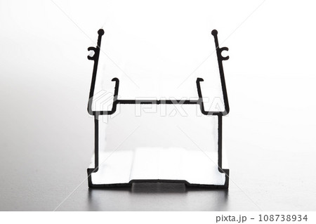 The material is an aluminum profile for the manufacture of windows and suspended ceilings. Close-up 108738934