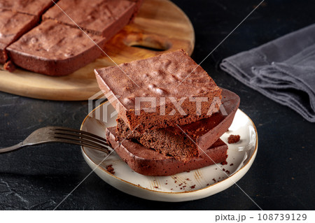 Chocolate brownie, simple coffee cake, on a black slate background 108739129