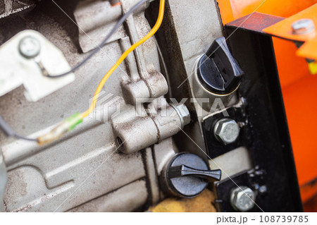 holes for pouring gear oil into the walk-behind tractor. Maintenance of equipment, industry. Close-up holes for pouring gear oil into the walk-behind tractor. Maintenance of equipment, industry. Close-up 108739785