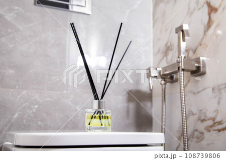 Aroma diffuser air freshener stands on a hanging toilet bowl in the toilet. The concept of a pleasant aroma in the toilet. Copy space for text Aroma diffuser air freshener stands on a hanging toilet bowl in the toilet. The concept of a pleasant aroma in the toilet. Copy space for text 108739806