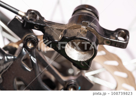 A disassembled bicycle caliper for its maintenance and replacement of brake pads on a disc brake system. A disassembled bicycle caliper for its maintenance and replacement of brake pads on a disc brake system. 108739823