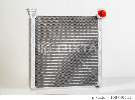 Aluminum radiator of a car stove on a white background, close-up, isolated Aluminum radiator of a car stove on a white background, close-up, isolated 108740513