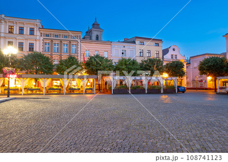 beautiful street restaurants with illuminated and flowers on the market in Leszno at dusk. Poland 108741123
