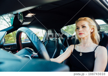 female driver behind the wheel of a taxi driver female driver behind the wheel of a taxi driver 108743010