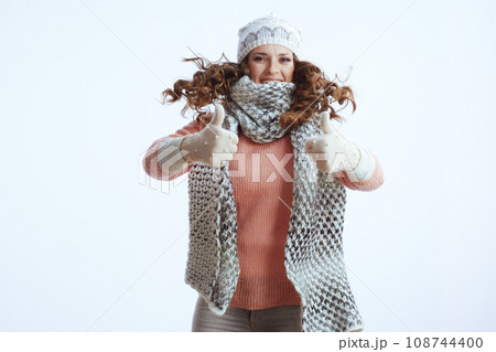 stylish woman on white showing thumbs up and jumping 108744400