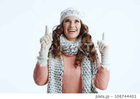 smiling stylish female on white pointing up on copy space smiling stylish female on white pointing up on copy space 108744401
