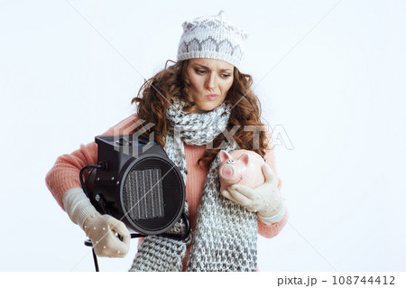 stylish female in sweater, mittens, hat and scarf on white stylish female in sweater, mittens, hat and scarf on white 108744412
